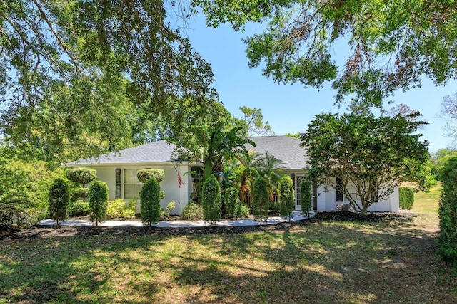 11442 Beggs Ct, Clermont, FL 34711 - view of front of property with a front lawn, stucco siding, and roof with shingles