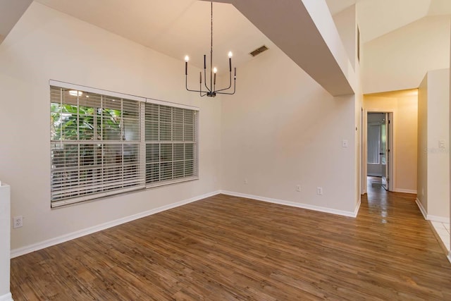 11442 Beggs Ct, Clermont, FL 34711 - unfurnished dining area featuring a chandelier, wood finished floors, high vaulted ceiling, and baseboards