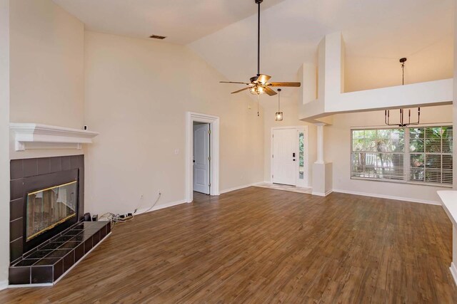 11442 Beggs Ct, Clermont, FL 34711 - unfurnished living room with a fireplace, wood finished floors, a ceiling fan, baseboards, and high vaulted ceiling