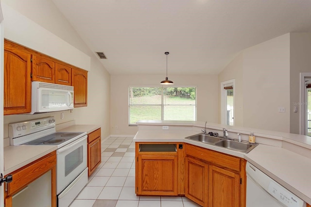 11442 Beggs Ct, Clermont, FL 34711 - kitchen featuring white appliances, a sink, vaulted ceiling, light countertops, and brown cabinets