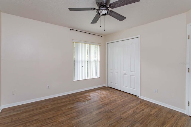 11442 Beggs Ct, Clermont, FL 34711 - unfurnished bedroom with wood finished floors, baseboards, a closet, and a ceiling fan