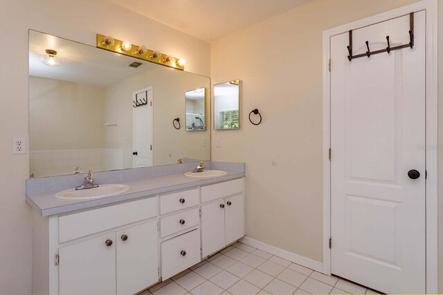 11442 Beggs Ct, Clermont, FL 34711 - full bath with double vanity, tile patterned flooring, and baseboards