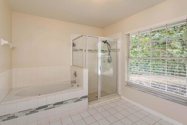 11442 Beggs Ct, Clermont, FL 34711 - bathroom featuring a shower stall, tile patterned flooring, healthy amount of natural light, and a garden tub