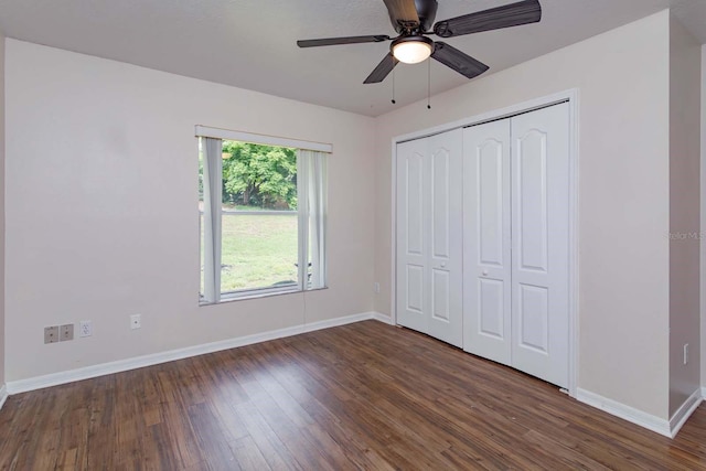 11442 Beggs Ct, Clermont, FL 34711 - unfurnished bedroom featuring dark wood-style floors, baseboards, a closet, and a ceiling fan