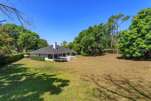 11442 Beggs Ct, Clermont, FL 34711 - view of green lawn with a trampoline