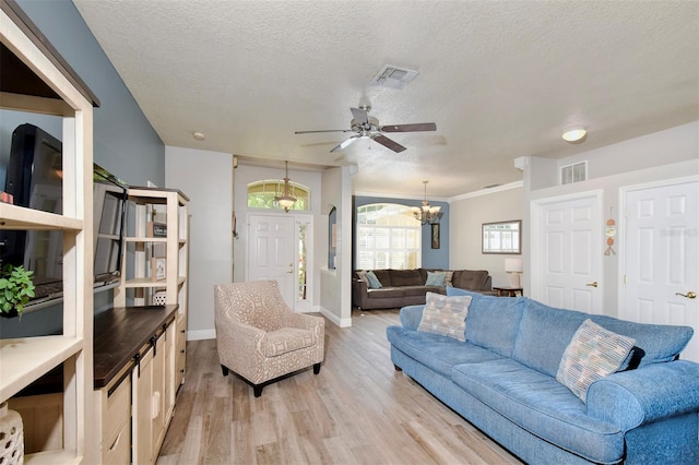 3732 Fallscrest Cir, Clermont, FL 34711 - living area with light wood-style floors, a chandelier, a ceiling fan, a textured ceiling, and baseboards