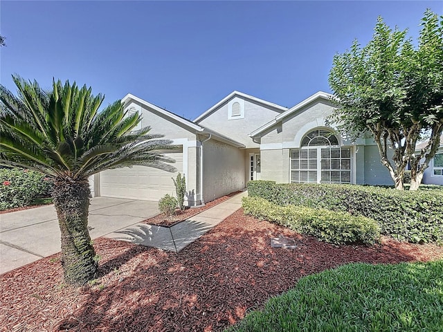 ranch-style home with stucco siding, driveway, and an attached garage