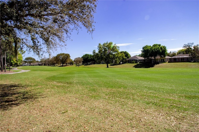 view of green lawn featuring golf course view