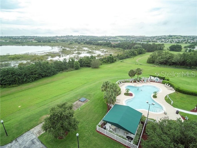 drone / aerial view of a large body of water and a pool