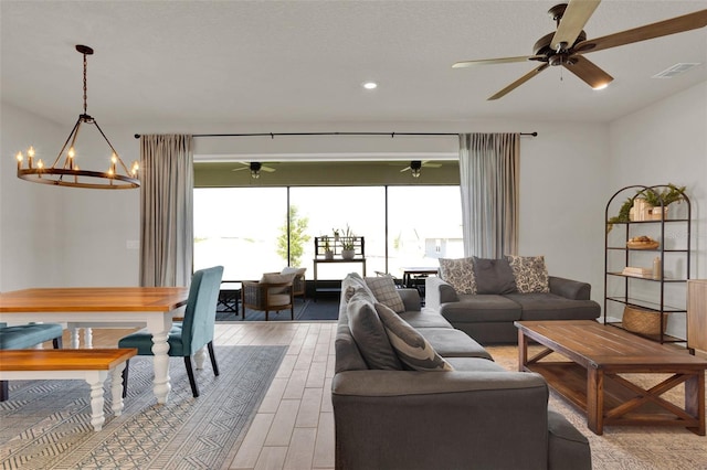 living area with a chandelier, light wood-style floors, a ceiling fan, and recessed lighting