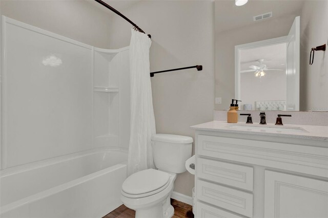 bathroom featuring toilet, wood finished floors, vanity, shower / tub combo, and ceiling fan