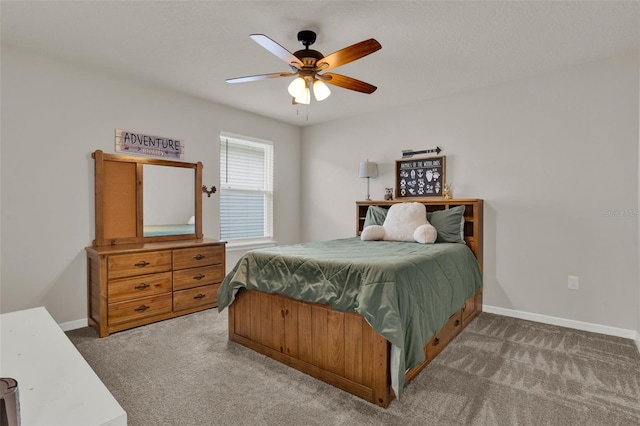 carpeted bedroom featuring baseboards and a ceiling fan