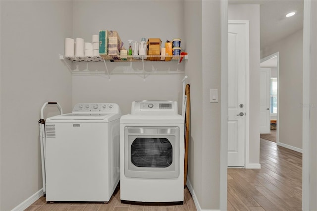 washroom with washer and clothes dryer, light wood finished floors, baseboards, and recessed lighting