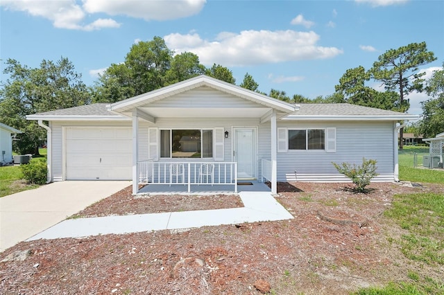 11214 SW 77th Ct, Ocala, FL 34476 - ranch-style home featuring a porch, an attached garage, concrete driveway, roof with shingles, and cooling unit