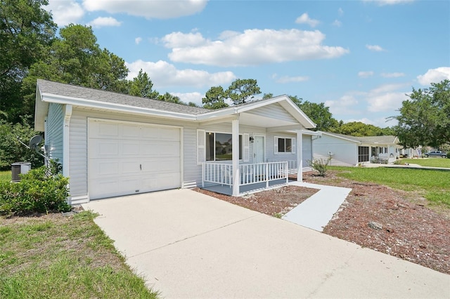 11214 SW 77th Ct, Ocala, FL 34476 - ranch-style home featuring a porch, a garage, concrete driveway, cooling unit, and a front yard