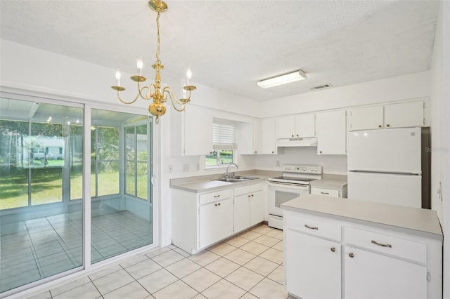 11214 SW 77th Ct, Ocala, FL 34476 - kitchen with white appliances, a chandelier, light countertops, white cabinets, and a textured ceiling