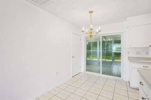 11214 SW 77th Ct, Ocala, FL 34476 - unfurnished dining area with a chandelier, light tile patterned floors, and baseboards