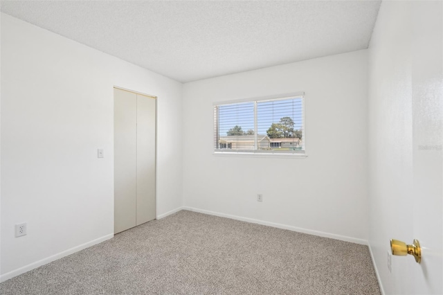 11214 SW 77th Ct, Ocala, FL 34476 - spare room featuring carpet floors, baseboards, and a textured ceiling