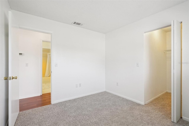 11214 SW 77th Ct, Ocala, FL 34476 - unfurnished bedroom featuring carpet floors, a walk in closet, a closet, and baseboards