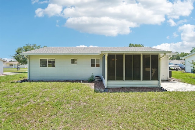 11214 SW 77th Ct, Ocala, FL 34476 - rear view of property featuring a sunroom and a lawn