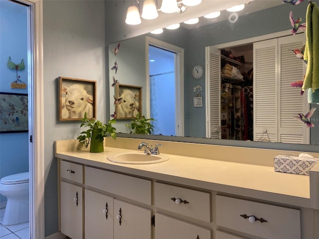 bathroom featuring a closet, vanity, and toilet