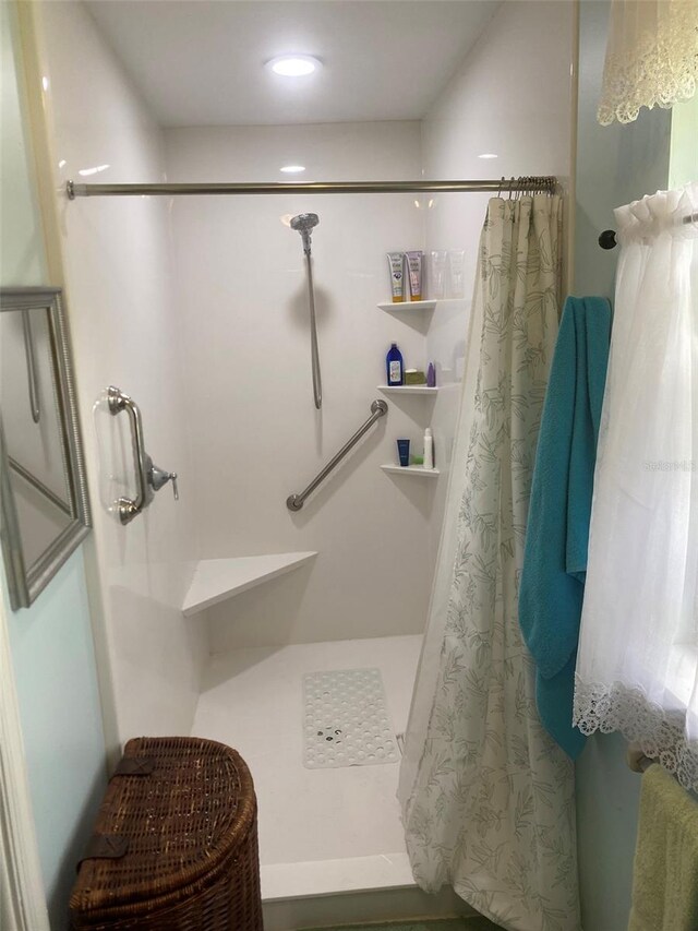 full bath with a shower stall