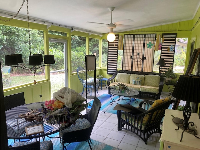 sunroom featuring tile patterned floors, an outdoor hangout area, a ceiling fan, healthy amount of natural light, and vaulted ceiling