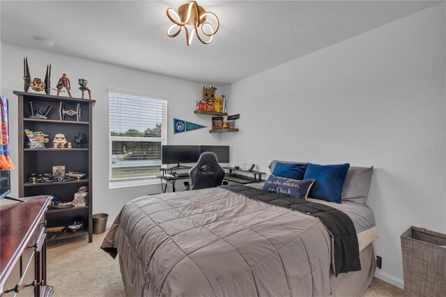 2552 Chickasaw Plum Loop, Clermont, FL 34711 - bedroom with light carpet, a desk, and a chandelier