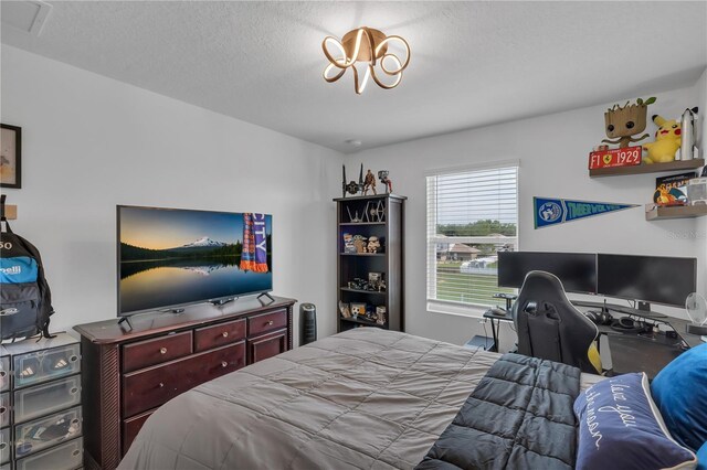 2552 Chickasaw Plum Loop, Clermont, FL 34711 - bedroom featuring a textured ceiling