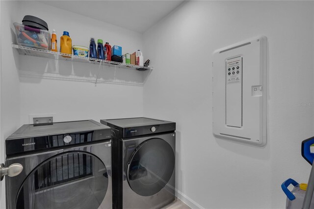 2552 Chickasaw Plum Loop, Clermont, FL 34711 - laundry area with washer and clothes dryer and baseboards