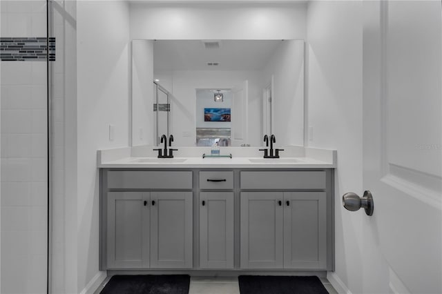 2552 Chickasaw Plum Loop, Clermont, FL 34711 - bathroom featuring double vanity, baseboards, and a tile shower