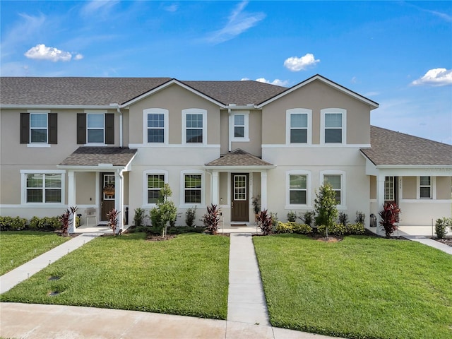 2552 Chickasaw Plum Loop, Clermont, FL 34711 - view of property featuring a front lawn, stucco siding, and roof with shingles