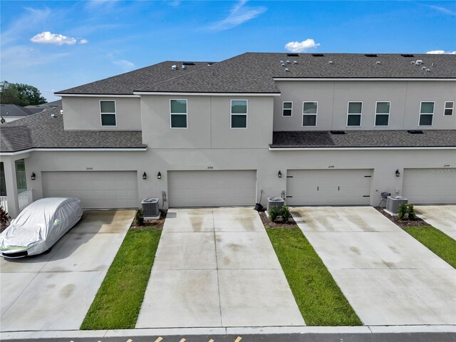 2552 Chickasaw Plum Loop, Clermont, FL 34711 - multi unit property featuring an attached garage, stucco siding, a shingled roof, driveway, and cooling unit