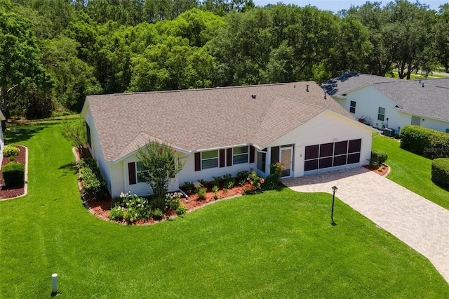 26608 Racquet Cir, Leesburg, FL 34748 - single story home featuring driveway, a front lawn, roof with shingles, and an attached garage