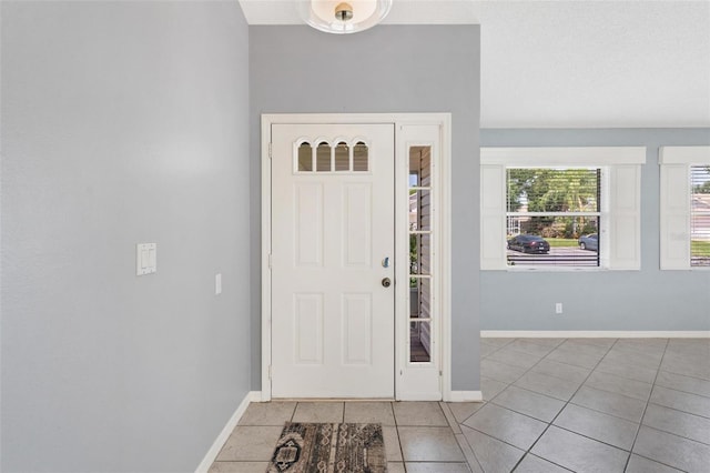 26608 Racquet Cir, Leesburg, FL 34748 - foyer with light tile patterned flooring and baseboards