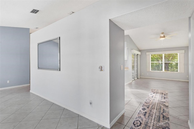 26608 Racquet Cir, Leesburg, FL 34748 - unfurnished room featuring a ceiling fan, light tile patterned floors, vaulted ceiling, and baseboards