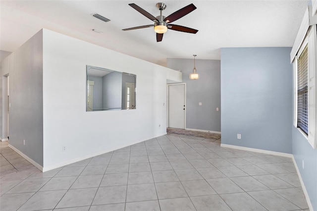 26608 Racquet Cir, Leesburg, FL 34748 - empty room with ceiling fan, light tile patterned floors, lofted ceiling, and baseboards