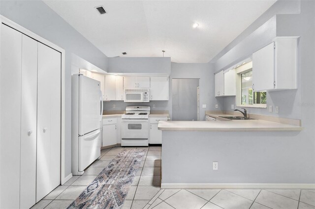 26608 Racquet Cir, Leesburg, FL 34748 - kitchen featuring white appliances, a sink, a peninsula, light countertops, and lofted ceiling