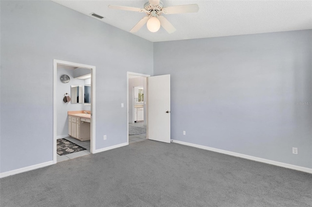 26608 Racquet Cir, Leesburg, FL 34748 - unfurnished bedroom with carpet, baseboards, connected bathroom, high vaulted ceiling, and ceiling fan