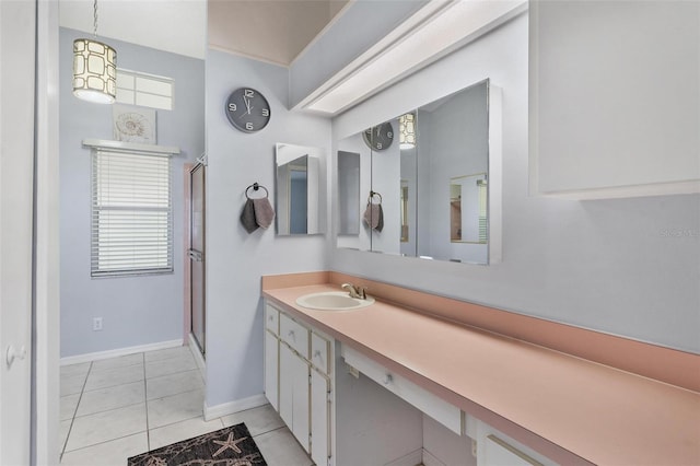 26608 Racquet Cir, Leesburg, FL 34748 - bathroom featuring a shower with shower door, vanity, baseboards, and tile patterned flooring