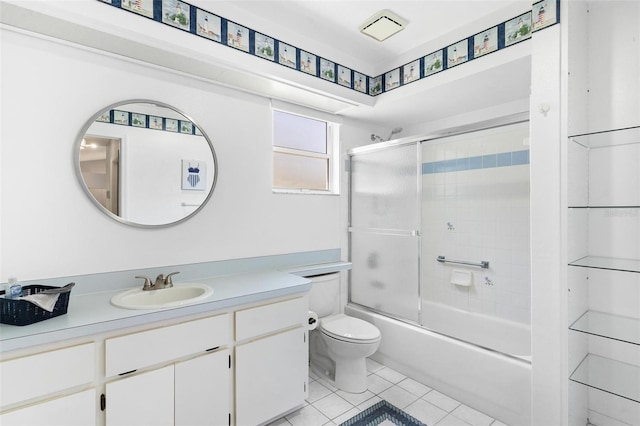 26608 Racquet Cir, Leesburg, FL 34748 - bathroom featuring tile patterned floors, toilet, vanity, and combined bath / shower with glass door