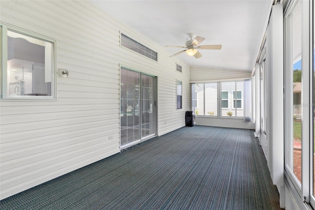 26608 Racquet Cir, Leesburg, FL 34748 - unfurnished sunroom featuring ceiling fan, lofted ceiling, carpet floors, and wood walls
