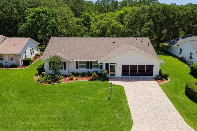 26608 Racquet Cir, Leesburg, FL 34748 - ranch-style home with decorative driveway, a garage, and a front lawn