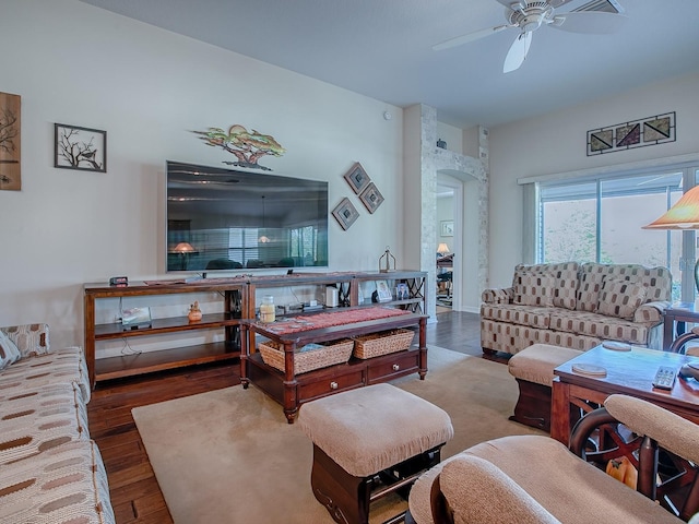 3136 Vandenberg Ct, The Villages, FL 32163 - living area with a ceiling fan, wood finished floors, and arched walkways
