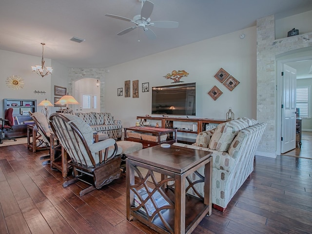 3136 Vandenberg Ct, The Villages, FL 32163 - living area featuring a ceiling fan, dark wood finished floors, arched walkways, and a chandelier