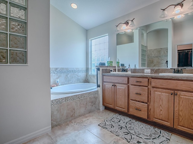3136 Vandenberg Ct, The Villages, FL 32163 - bathroom with a garden tub, double vanity, tile patterned flooring, and vaulted ceiling