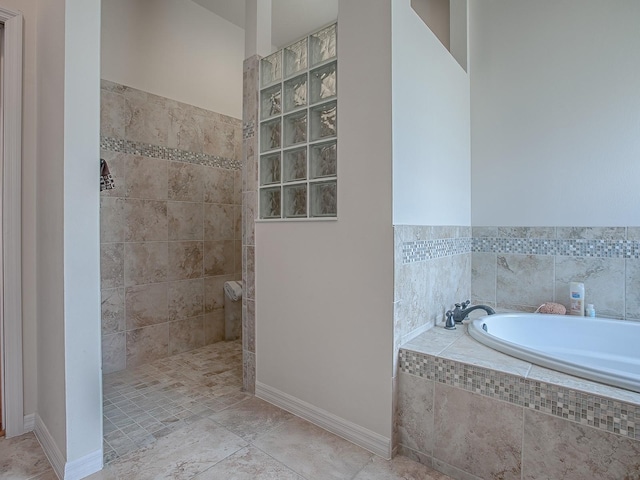 3136 Vandenberg Ct, The Villages, FL 32163 - full bath featuring a garden tub, walk in shower, and baseboards