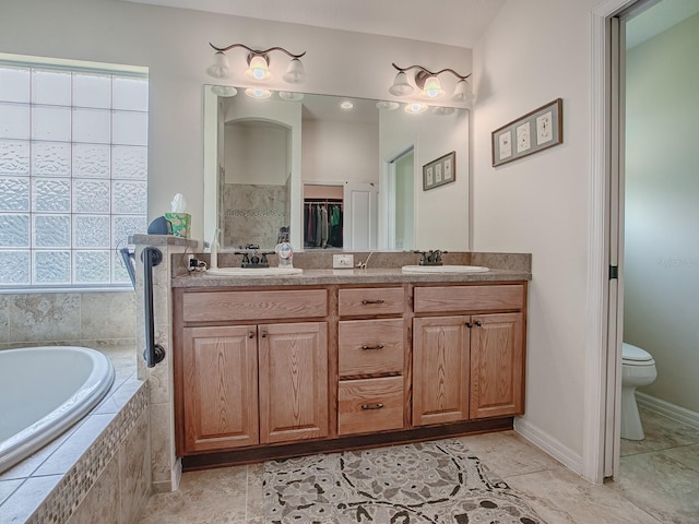 3136 Vandenberg Ct, The Villages, FL 32163 - bathroom with double vanity, a bath, and toilet