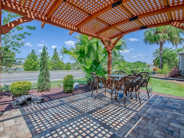 3136 Vandenberg Ct, The Villages, FL 32163 - view of patio featuring a pergola, outdoor dining space, and a water view