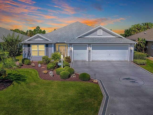 3136 Vandenberg Ct, The Villages, FL 32163 - ranch-style home featuring a shingled roof, concrete driveway, a lawn, and an attached garage